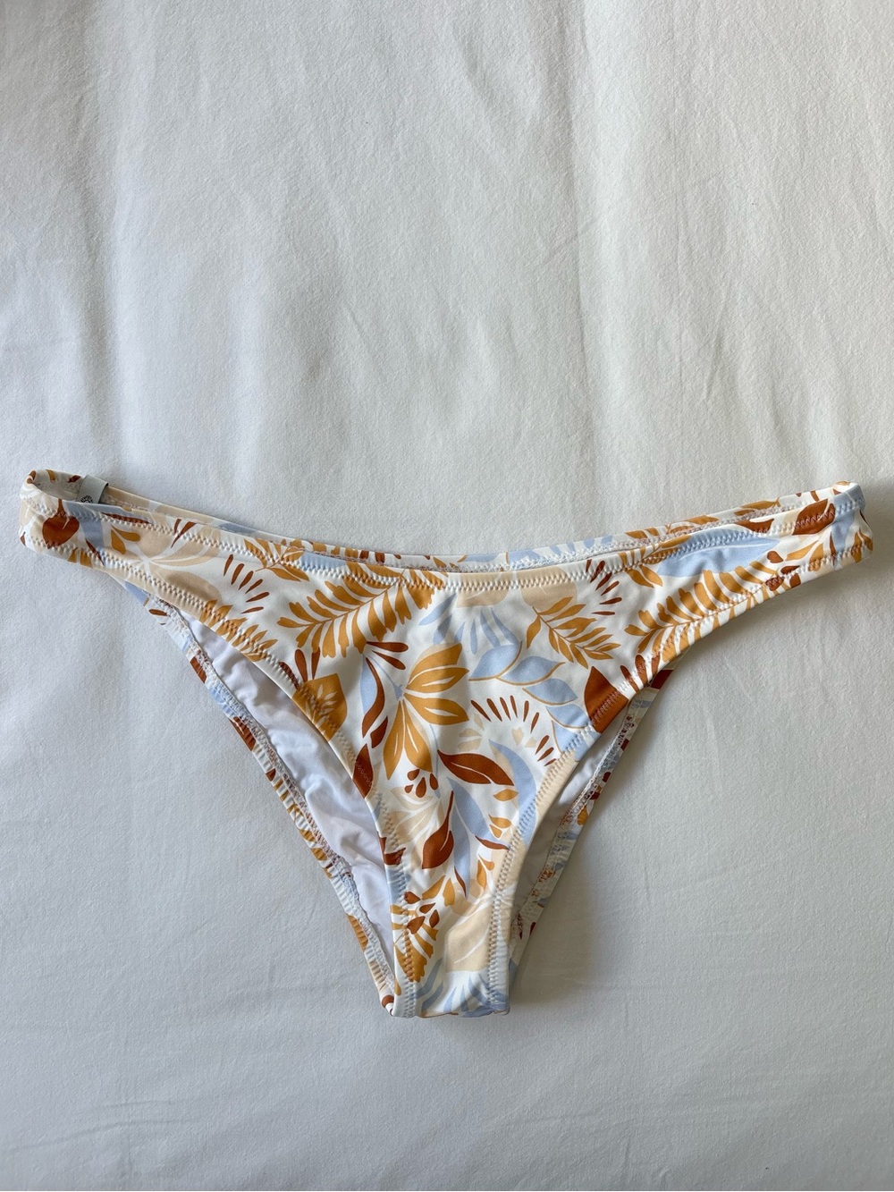 PacSun Rhythm. white bikini bottom with tan and blue botanical print